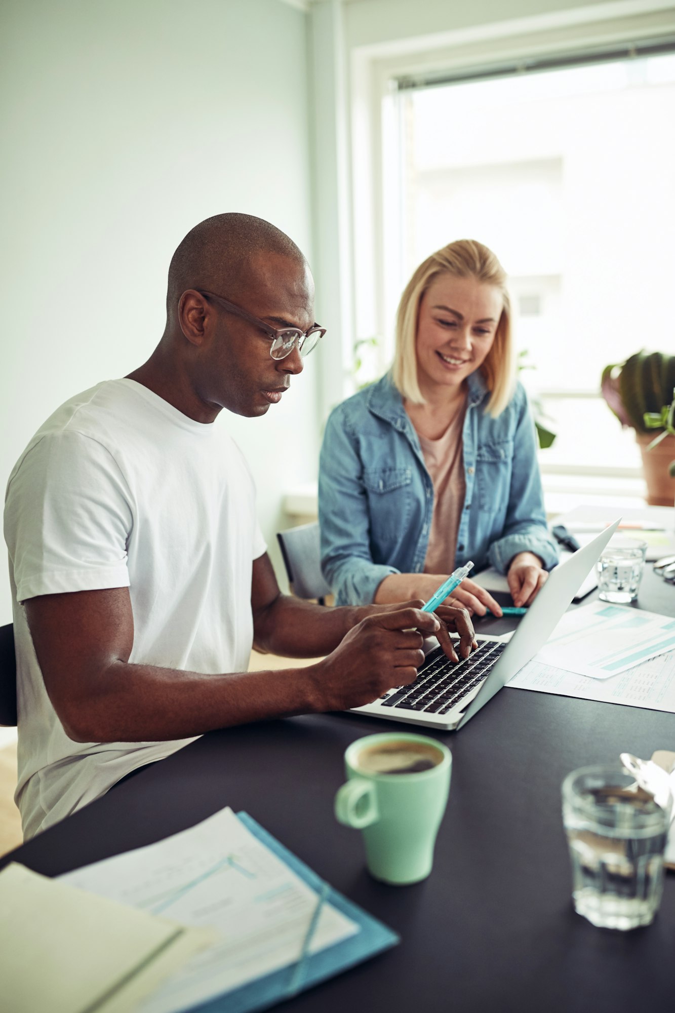 Diverse businesspeople working online with a laptop in an office